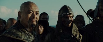 Movie still from “Pirates of the Caribbean: At World's End” (2007), directed by Gore Verbinski – A group of men standing next to each other on top of a hill; Close Up shot, Over the shoulder angle