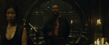 Movie still from “Pirates of the Caribbean: At World's End” (2007), directed by Gore Verbinski – A man with a long beard standing in front of a mirror; Medium shot, Low angle