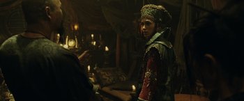 Movie still from “Pirates of the Caribbean: At World's End” (2007), directed by Gore Verbinski – A man wearing a crown and a red jacket; Medium shot, Over the shoulder angle
