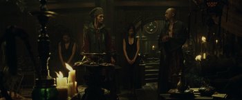 Movie still from “Pirates of the Caribbean: At World's End” (2007), directed by Gore Verbinski – A group of people standing around a table; Wide shot, Over the shoulder angle