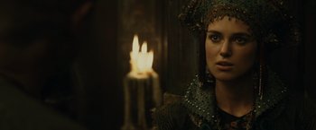 Movie still from “Pirates of the Caribbean: At World's End” (2007), directed by Gore Verbinski – A person with a candle in the background; Close Up shot, Over the shoulder angle