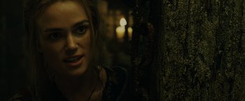 Movie still from “Pirates of the Caribbean: At World's End” (2007), directed by Gore Verbinski – A person with a candle in the background; Close Up shot, Over the shoulder angle