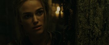 Movie still from “Pirates of the Caribbean: At World's End” (2007), directed by Gore Verbinski – A woman's face in a dark room; Close Up shot, Over the shoulder angle