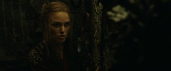 Movie still from “Pirates of the Caribbean: At World's End” (2007), directed by Gore Verbinski – A woman standing next to a tree in the dark; Close Up shot, Over the shoulder angle