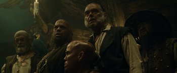 Movie still from “Pirates of the Caribbean: At World's End” (2007), directed by Gore Verbinski – A group of men standing next to each other in a cave; Close Up shot, Low angle