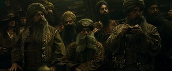 Movie still from “Pirates of the Caribbean: At World's End” (2007), directed by Gore Verbinski – A group of men wearing turbans and beards; Medium shot, Low angle
