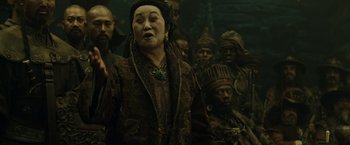 Movie still from “Pirates of the Caribbean: At World's End” (2007), directed by Gore Verbinski – An older woman standing in front of a group of men; Medium shot, Over the shoulder angle