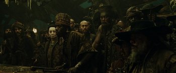 Movie still from “Pirates of the Caribbean: At World's End” (2007), directed by Gore Verbinski – A group of men standing next to each other in a room; Medium shot, High angle