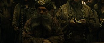 Movie still from “Pirates of the Caribbean: At World's End” (2007), directed by Gore Verbinski – A man with long hair and a beard wearing a turban; Medium shot, Over the shoulder angle