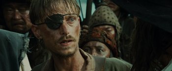 Movie still from “Pirates of the Caribbean: At World's End” (2007), directed by Gore Verbinski – A person wearing a pirate eye patch; Close Up shot, Over the shoulder angle