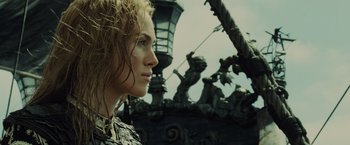 Movie still from “Pirates of the Caribbean: At World's End” (2007), directed by Gore Verbinski – A woman's face in front of statues; Close Up shot, Low angle