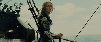 Movie still from “Pirates of the Caribbean: At World's End” (2007), directed by Gore Verbinski – A woman standing on top of a boat in the water; Medium shot, Low angle