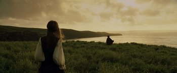 Movie still from “Pirates of the Caribbean: At World's End” (2007), directed by Gore Verbinski – Two people sitting on a hill overlooking the ocean; Extreme Wide shot, Over the shoulder angle