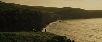 Movie still from “Pirates of the Caribbean: At World's End” (2007), directed by Gore Verbinski – Two people sitting on a hill overlooking the ocean; Extreme Wide shot, High angle