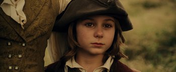 Movie still from “Pirates of the Caribbean: At World's End” (2007), directed by Gore Verbinski – A young girl wearing a hat and looking at the camera; Close Up shot, Low angle