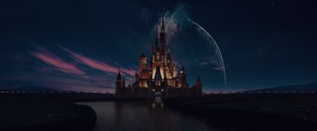 A large castle with lights on it's side