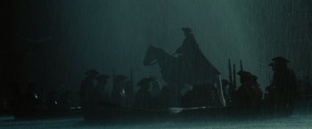 Movie still from “Pirates of the Caribbean: Dead Man's Chest” (2006), directed by Gore Verbinski – A man on a horse in the rain; Wide shot, Low angle
