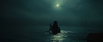 Movie still from “Pirates of the Caribbean: Dead Man's Chest” (2006), directed by Gore Verbinski – A person on a boat in the middle of the night; Extreme Wide shot, Low angle