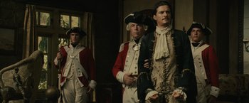 Movie still from “Pirates of the Caribbean: Dead Man's Chest” (2006), directed by Gore Verbinski – A group of men standing next to each other in uniforms; Medium shot, Low angle