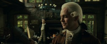 Movie still from “Pirates of the Caribbean: Dead Man's Chest” (2006), directed by Gore Verbinski – A man in a wig standing in front of a fireplace; Medium shot, Over the shoulder angle