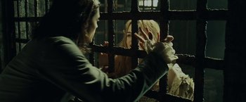 Movie still from “Pirates of the Caribbean: Dead Man's Chest” (2006), directed by Gore Verbinski – A woman is holding a cell phone in her hand; Medium shot, Over the shoulder angle