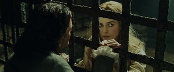Movie still from “Pirates of the Caribbean: Dead Man's Chest” (2006), directed by Gore Verbinski – A woman looking at a man through a fence; Close Up shot, Over the shoulder angle