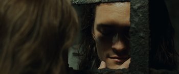 Movie still from “Pirates of the Caribbean: Dead Man's Chest” (2006), directed by Gore Verbinski – A man with long hair looking in a mirror; Close Up shot, Over the shoulder angle