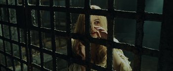 Movie still from “Pirates of the Caribbean: Dead Man's Chest” (2006), directed by Gore Verbinski – A woman looking through the bars of a jail cell; Close Up shot, High angle