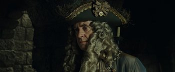 Movie still from “Pirates of the Caribbean: Dead Man's Chest” (2006), directed by Gore Verbinski – A person wearing a hat and a wig; Close Up shot, Over the shoulder angle