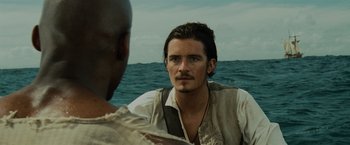 Movie still from “Pirates of the Caribbean: Dead Man's Chest” (2006), directed by Gore Verbinski – A man with a beard is sitting on a boat; Close Up shot, Over the shoulder angle