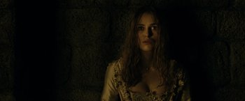 Movie still from “Pirates of the Caribbean: Dead Man's Chest” (2006), directed by Gore Verbinski – A woman with long brown hair wearing a white dress; Close Up shot, High angle