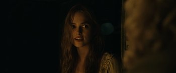 Movie still from “Pirates of the Caribbean: Dead Man's Chest” (2006), directed by Gore Verbinski – A woman with long brown hair is looking at the camera; Close Up shot, Over the shoulder angle