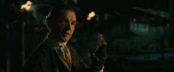 Movie still from “Pirates of the Caribbean: Dead Man's Chest” (2006), directed by Gore Verbinski – A man holding a piece of paper in his hand; Close Up shot, Over the shoulder angle