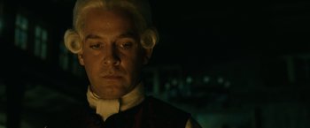 Movie still from “Pirates of the Caribbean: Dead Man's Chest” (2006), directed by Gore Verbinski – A person wearing a suit and a wig; Close Up shot, Low angle