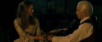 Movie still from “Pirates of the Caribbean: Dead Man's Chest” (2006), directed by Gore Verbinski – A woman is holding a gun in her hand; Medium shot, Over the shoulder angle