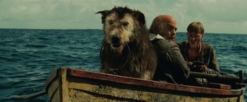 Movie still from “Pirates of the Caribbean: Dead Man's Chest” (2006), directed by Gore Verbinski – A man and a dog in a boat in the water; Medium shot, Low angle