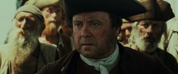 Movie still from “Pirates of the Caribbean: Dead Man's Chest” (2006), directed by Gore Verbinski – A man with a beard and a black hat; Close Up shot, Over the shoulder angle