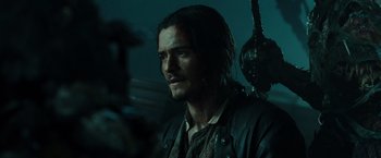 Movie still from “Pirates of the Caribbean: Dead Man's Chest” (2006), directed by Gore Verbinski – A person wearing a pirate costume; Close Up shot, Over the shoulder angle