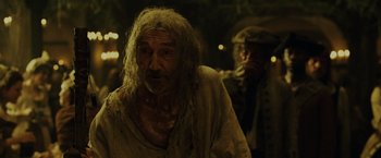 Movie still from “Pirates of the Caribbean: Dead Man's Chest” (2006), directed by Gore Verbinski – An old man with long hair and a beard; Medium shot, Over the shoulder angle