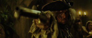 Movie still from “Pirates of the Caribbean: Dead Man's Chest” (2006), directed by Gore Verbinski – A man dressed as a pirate holding a sword; Close Up shot, Over the shoulder angle