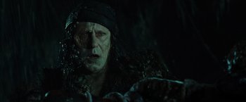 Movie still from “Pirates of the Caribbean: Dead Man's Chest” (2006), directed by Gore Verbinski – An old man with a beard is looking at the camera; Close Up shot, Over the shoulder angle