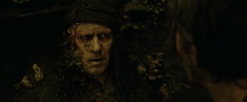 Movie still from “Pirates of the Caribbean: Dead Man's Chest” (2006), directed by Gore Verbinski – A person wearing a pirate costume; Close Up shot, High angle