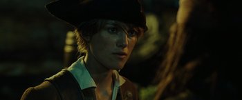 Movie still from “Pirates of the Caribbean: Dead Man's Chest” (2006), directed by Gore Verbinski – A young man wearing a black hat and a jacket; Close Up shot, Over the shoulder angle