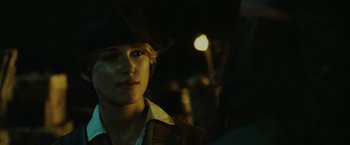 Movie still from “Pirates of the Caribbean: Dead Man's Chest” (2006), directed by Gore Verbinski – A woman wearing a cowboy hat in the dark; Close Up shot, Over the shoulder angle