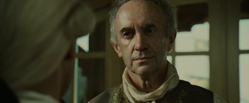 Movie still from “Pirates of the Caribbean: Dead Man's Chest” (2006), directed by Gore Verbinski – An older man wearing a neck scarf and a neck tie; Close Up shot, Low angle