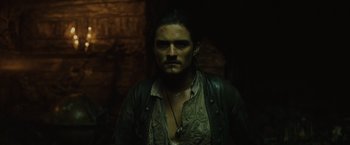 Movie still from “Pirates of the Caribbean: Dead Man's Chest” (2006), directed by Gore Verbinski – A person wearing a shirt and a necklace; Close Up shot, Low angle