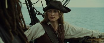 Movie still from “Pirates of the Caribbean: Dead Man's Chest” (2006), directed by Gore Verbinski – A woman wearing a pirate's hat on a boat; Close Up shot, Low angle