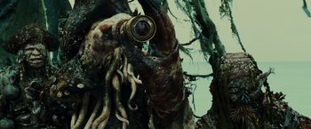 Movie still from “Pirates of the Caribbean: Dead Man's Chest” (2006), directed by Gore Verbinski – An octopus with tentacles hanging from a tree; Close Up shot, Over the shoulder angle