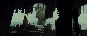 Movie still from “Pirates of the Caribbean: Dead Man's Chest” (2006), directed by Gore Verbinski – An island in the middle of the ocean with trees in the background; Extreme Wide shot, Low angle