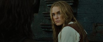 Movie still from “Pirates of the Caribbean: Dead Man's Chest” (2006), directed by Gore Verbinski – A woman with long blonde hair wearing a white shirt and brown tie; Close Up shot, Over the shoulder angle